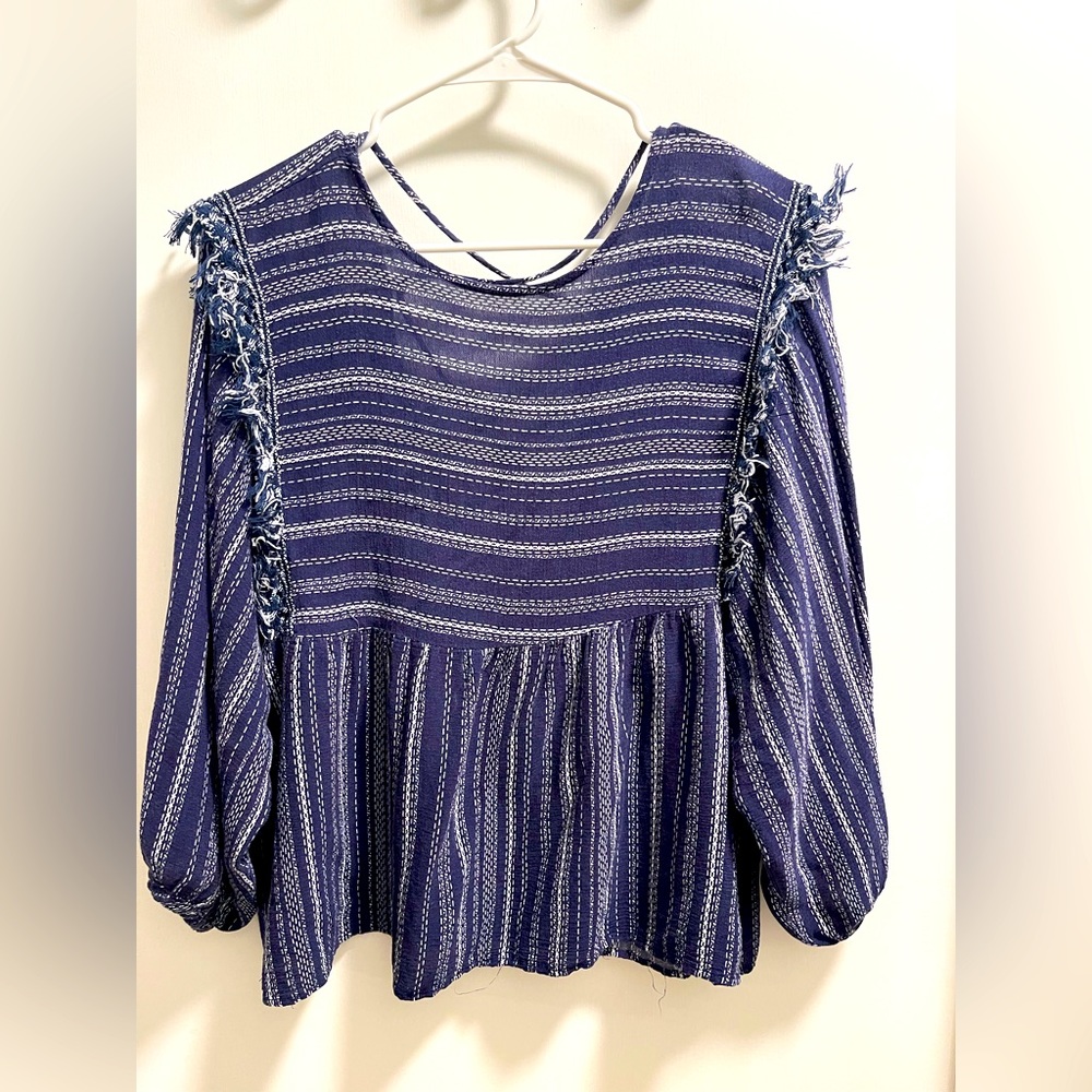 Used. Good condition. Navy and white fringe top.